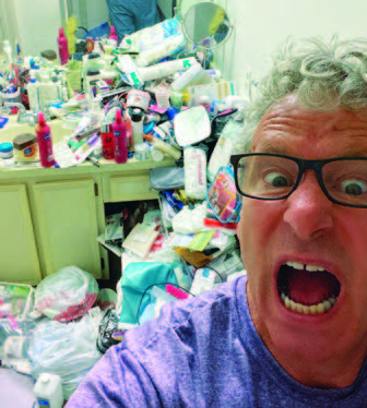 David Hall surrounded by clutter before an organizing session
